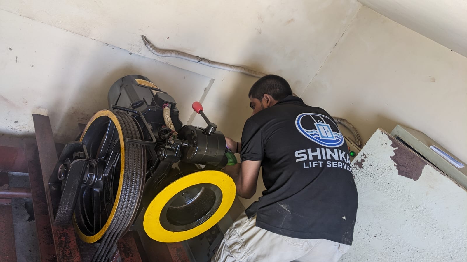 Shinkai team member inspecting elevator equipment